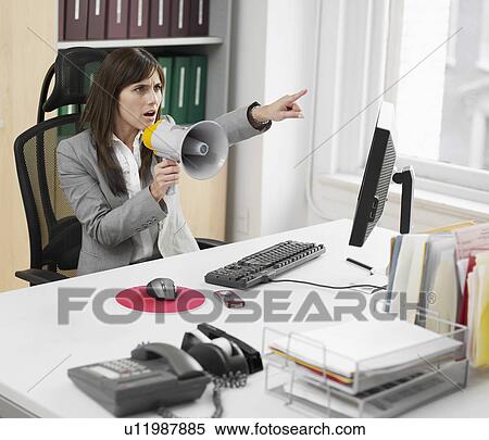 Stock Photography - Female Office Worker Using Megaphone. Fotosearch