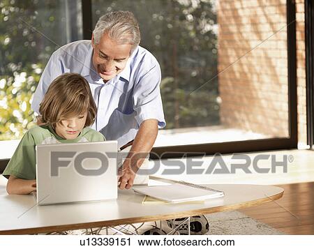 Grandson and grandfather using laptop computer View Large Photo Image Stock Image - Grandson and grandfather using laptop computer. Fotosearch