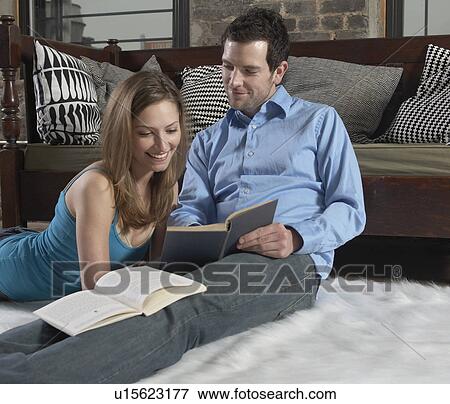 Mid-Adult Couple Reading on Floor View Large Photo Image Stock Photo - Mid-Adult Couple Reading on Floor. Fotosearch