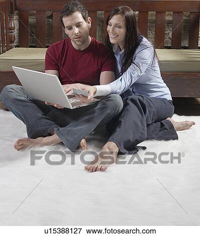 Stock Photo - Mid-Adult Couple Shopping Online. Fotosearch