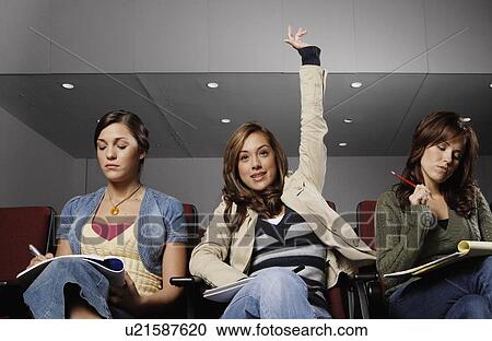 Three female students participating in lecture View Large Photo Image Stock Image - Three female students participating in lecture. Fotosearch