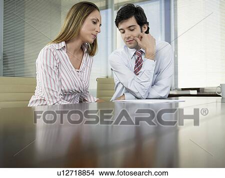 Two businesspeople having meeting (low angle view) View Large Photo Image Picture - Two businesspeople having meeting (low angle view). Fotosearch