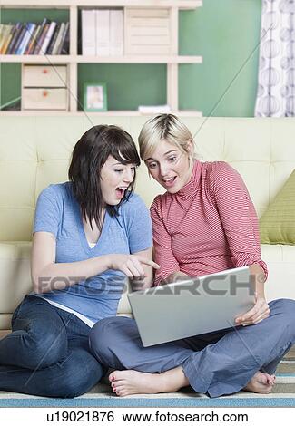 Two Surprised Young Women Using Laptop View Large Photo Image Stock Photograph - Two Surprised Young Women Using Laptop. Fotosearch