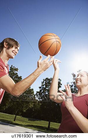 Woman and man spinning basketball on finger View Large Photo Image Stock Image - Woman and man spinning basketball on finger. Fotosearch