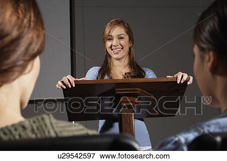 Woman giving a presentation to two students View Large Photo Image Stock Photo - Woman giving a presentation to two students. Fotosearch