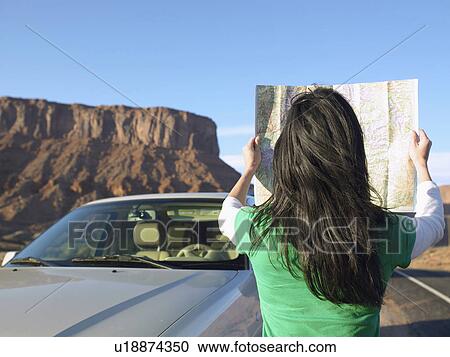 Woman reading map by car, rear view, Moab, Utah, USA View Large Photo Image Stock Image - Woman reading map by car, rear view, Moab, Utah, USA. Fotosearch