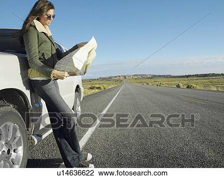 Woman reading road map by car on highway View Large Photo Image Stock Image - Woman reading road map by car on highway. Fotosearch