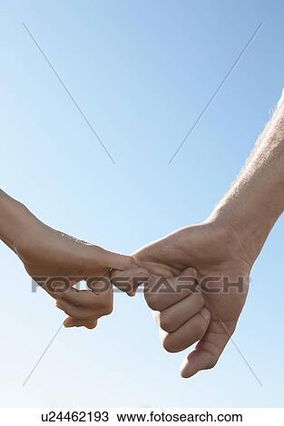 Young couple linking little fingers (focus on hands) View Large Photo Image Stock Image - Young couple linking little fingers (focus on hands). Fotosearch