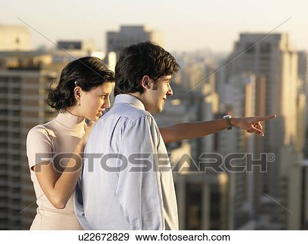 Young couple looking at view, Sao Paolo, Brazil View Large Photo Image Stock Photo - Young couple looking at view, Sao Paolo, Brazil. Fotosearch