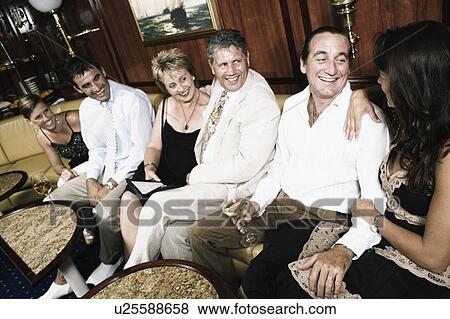 Group of people sitting on a couch and smiling in a sailing ship View Large Photo Image Stock Photo - Group of people sitting on a couch and smiling in a sailing ship. Fotosearch