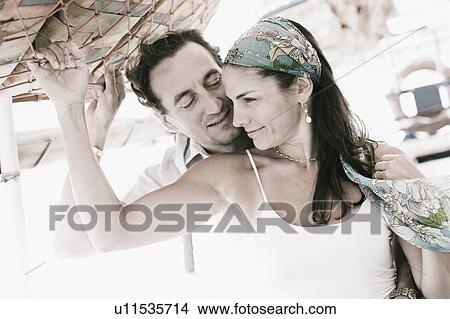 Mid adult couple romancing View Large Photo Image Picture - Mid adult couple romancing. Fotosearch