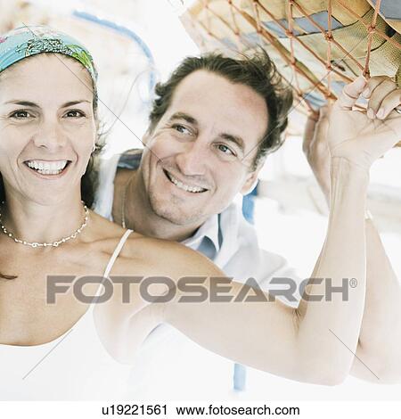 Stock Image - Mid adult couple smiling. Fotosearch