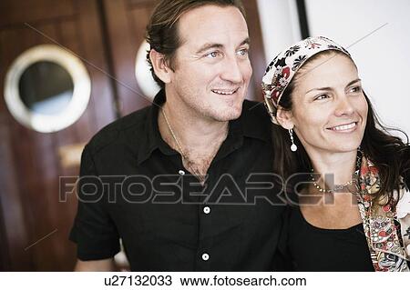 Mid adult couple smiling View Large Photo Image Stock Image - Mid adult couple smiling. Fotosearch