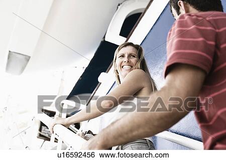 Mid adult couple walking up a staircase of a cruise ship and smiling View Large Photo Image Stock Photograph - Mid adult couple walking up a staircase of a cruise ship and smiling. Fotosearch