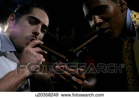 Stock Photograph of Close-up of young men lighting a cigar u20358249 ...