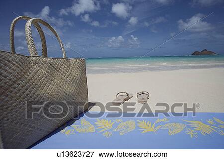 Close-up of a hand bag by slippers at beach View Large Photo Image Stock Photo - Close-up of a hand bag by slippers at beach. Fotosearch