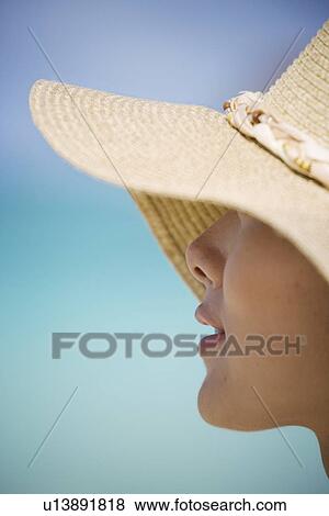 Close-up of a woman wearing hat View Large Photo Image Stock Photo - Close-up of a woman wearing hat. Fotosearch