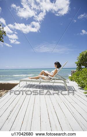 Stock Image - Profile of a woman reading book. Fotosearch
