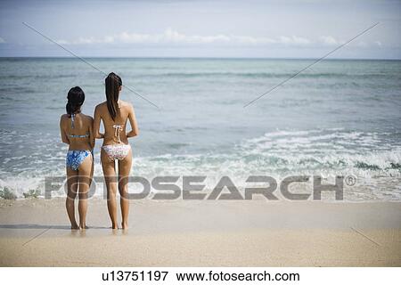 Rear view of women at beach View Large Photo Image Stock Photo - Rear view of women at beach. Fotosearch