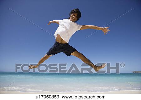 View of a man jumping View Large Photo Image Stock Photo - View of a man jumping. Fotosearch