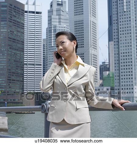 Stock Photography - Close-up of a businesswoman talking on a mobile phone. Fotosearch