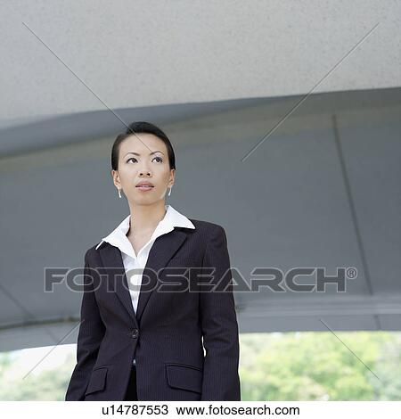 Low angle view of a businesswoman looking sideways View Large Photo Image Stock Image - Low angle view of a businesswoman looking sideways. Fotosearch