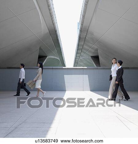 Side profile of three businesswomen and a businessman walking View Large Photo Image Stock Photo - Side profile of three businesswomen and a businessman walking. Fotosearch