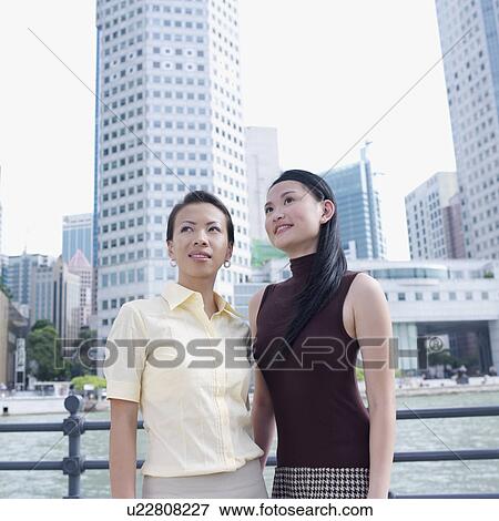 Stock Photo - Two businesswomen smiling. Fotosearch
