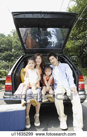 A family at the back of the van View Large Photo Image Stock Photo - A family at the back of the van. Fotosearch