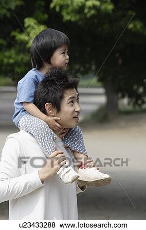 A father holding his son on shoulders View Large Photo Image Stock Photo - A father holding his son on shoulders. Fotosearch