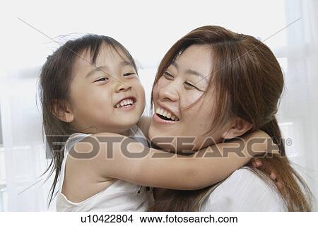 A young mother holding her daughter View Large Photo Image Picture - A young mother holding her daughter. Fotosearch