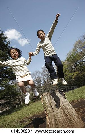 Children jumping from wooden log View Large Photo Image Stock Photo - Children jumping from wooden log. Fotosearch