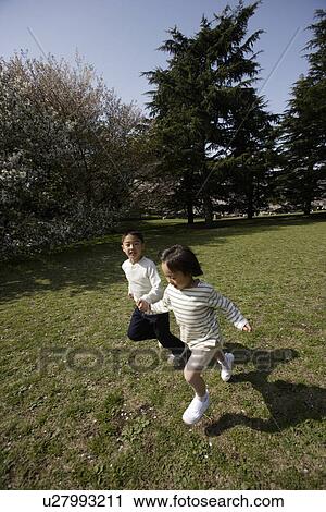 Children playing in garden View Large Photo Image Stock Image - Children playing in garden. Fotosearch