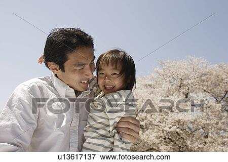 Stock Photo - Portrait of a father pampering daughter. Fotosearch