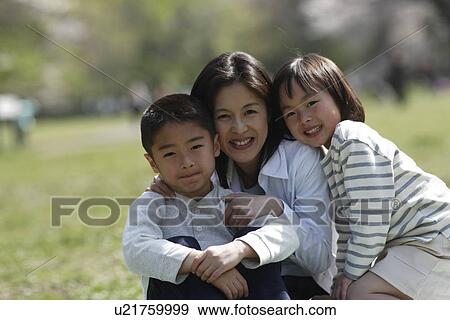 Portrait of a mother and children sitting in garden View Large Photo Image Stock Photo - Portrait of a mother and children sitting in garden. Fotosearch