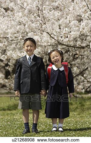 Stock Photo - Portrait of boy and girl smiling. Fotosearch