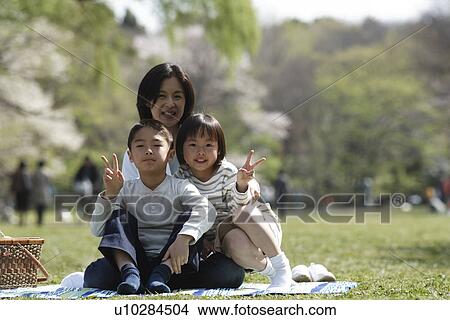 Portrait of children sitting with mother in garden View Large Photo Image Picture - Portrait of children sitting with mother in garden. Fotosearch