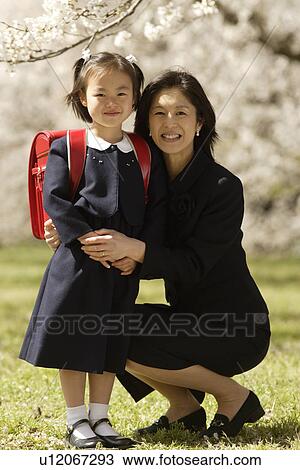 Portrait of mother and daughter smiling View Large Photo Image Stock Image - Portrait of mother and daughter smiling. Fotosearch