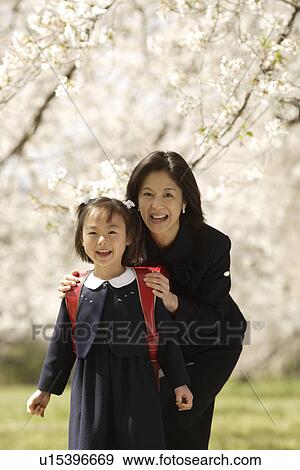 Stock Photo - Portrait of mother and daughter smiling. Fotosearch