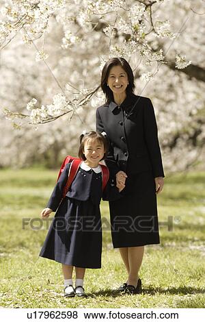 Portrait of mother and daughter standing under tree View Large Photo Image Stock Photo - Portrait of mother and daughter standing under tree. Fotosearch