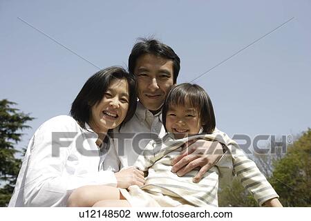 Portrait of parents smiling with daughter View Large Photo Image Stock Image - Portrait of parents smiling with daughter. Fotosearch