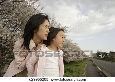 View of a daughter standing with mother View Large Photo Image Stock Photography - View of a daughter standing with mother. Fotosearch