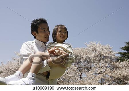 View of a father carrying daughter View Large Photo Image Stock Image - View of a father carrying daughter. Fotosearch