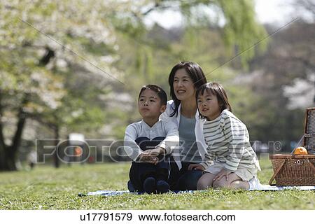 View of a mother and children sitting in garden View Large Photo Image Stock Photo - View of a mother and children sitting in garden. Fotosearch
