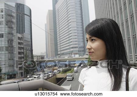 A woman seen smiling in a commercial area View Large Photo Image Picture - A woman seen smiling in a commercial area. Fotosearch
