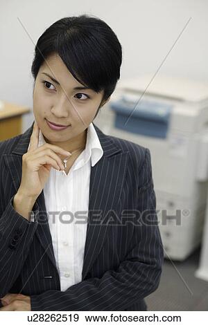 Stock Photo - The attention of professional woman riveted at something. Fotosearch