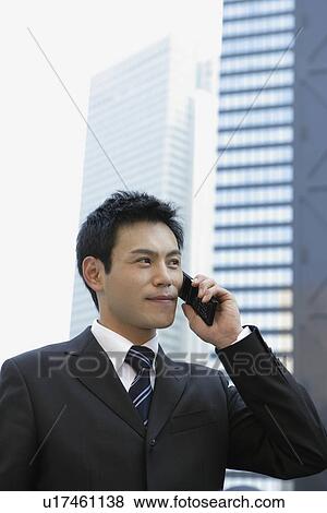 Businessman conversing on his cellphone, portrait View Large Photo Image Stock Photo - Businessman conversing on his cellphone, portrait. Fotosearch