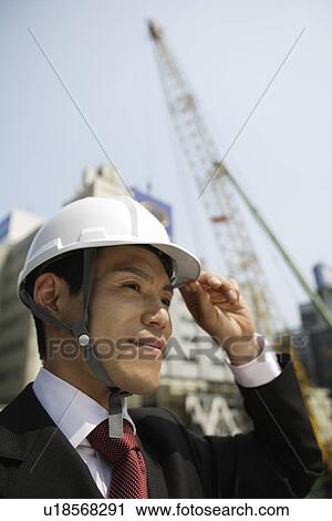 Businessman with a hard hat, portrait View Large Photo Image Stock Image - Businessman with a hard hat, portrait. Fotosearch