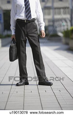 Stock Photo - Low angle view of a businessman. Fotosearch