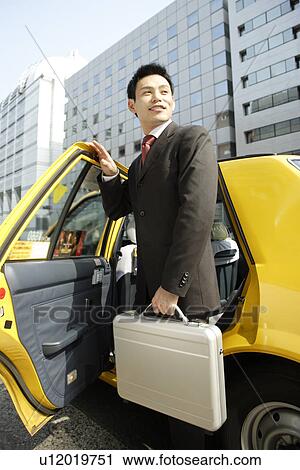 Man is stepping out of car, portrait View Large Photo Image Stock Image - Man is stepping out of car, portrait. Fotosearch